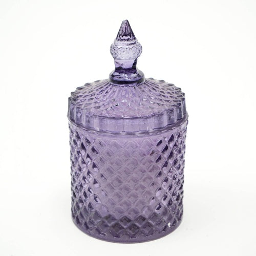 Plush Radiance Scented Wax Candle displayed in a beautiful mouth-blown glass vessel, showcasing its rich purple hue and artisanal craftsmanship.