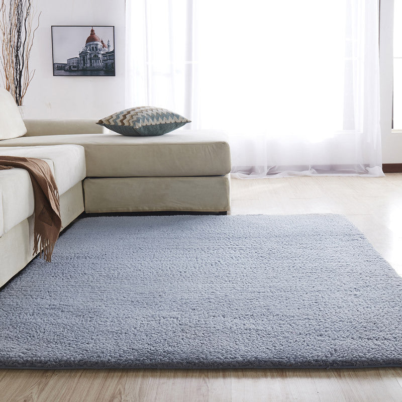 The Arctic Cashmere Rug adding a touch of elegance to a bedroom decor, perfect for enhancing home interiors.