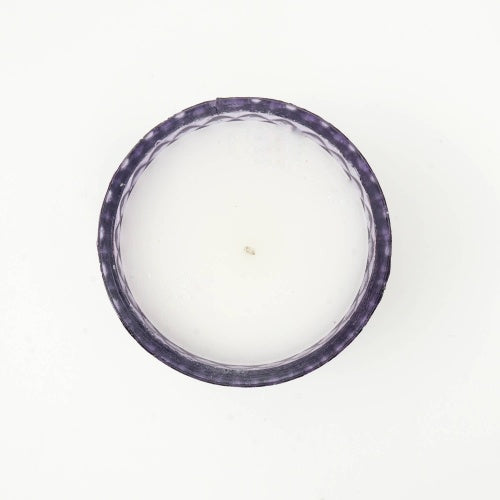 Plush Radiance Scented Wax Candle surrounded by soft fabrics, enhancing its luxurious appeal as a home decor accent.