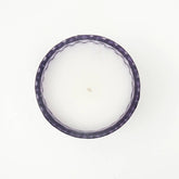 Plush Radiance Scented Wax Candle surrounded by soft fabrics, enhancing its luxurious appeal as a home decor accent.