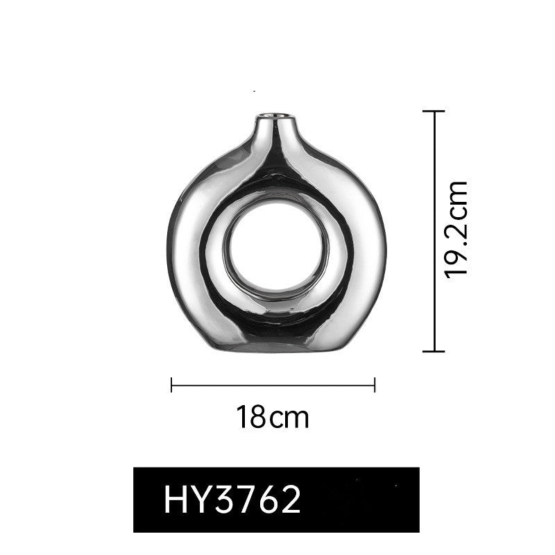 Charming décor setup featuring the Electroplated Silver Ceramic Vase with High-end Decoration, perfect for creating a sophisticated ambiance.