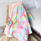 1 Piece Shaggy Blanket Plush Faux Fur Blanket draped over a sofa, demonstrating its colorful design and ultra-soft feel, perfect for cozy lounging.