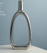 Nordic Style Heart Hollow Out Electroplated Ceramic Vase Decoration placed elegantly on a table with flowers.