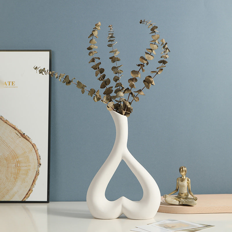 Elegant Nordic Style Heart Hollow Out Electroplated Ceramic Vase in silver, adding a luxurious touch to any space.