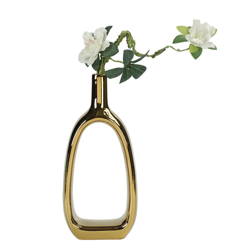 Beautiful Nordic Style Heart Hollow Out Electroplated Ceramic Vase displayed against a natural backdrop, perfect for gifting.